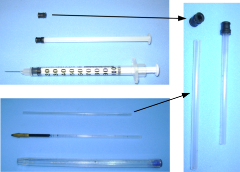 Tubo de caneta esferográfica com septo de seringa de insulina.